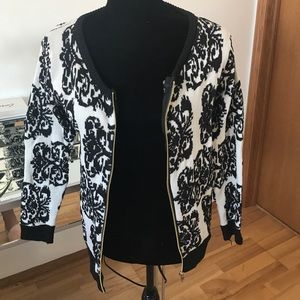 Black and white cardigan with gold zipper